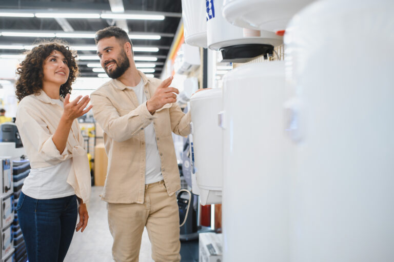 couple choosing water heater in electronics store