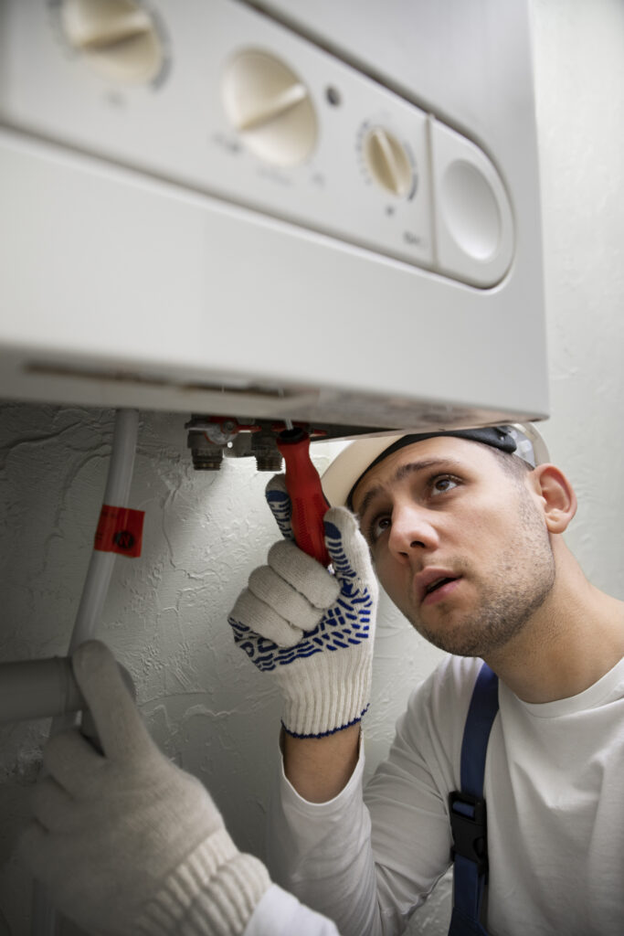 worker repairing water heater